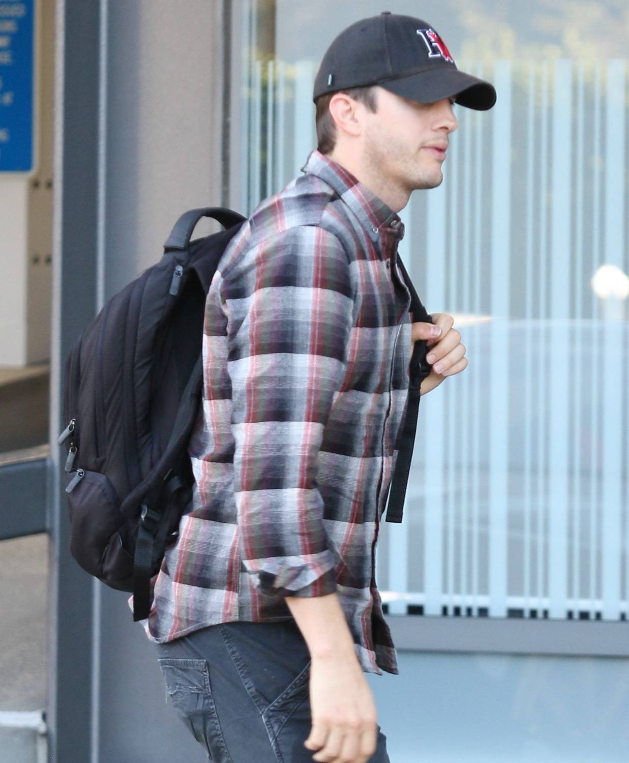 Ashton Kutcher heads to the studio for a meeting in plaid and wearing a backpack on December 9, 2014.
