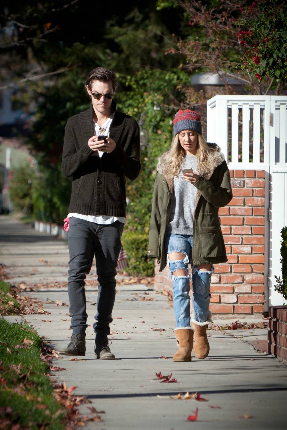 Ashley Tisdale and her husband, Christopher French, too busy on each other's cellphones while out for a stroll in Studio City in Los Angeles, California.
