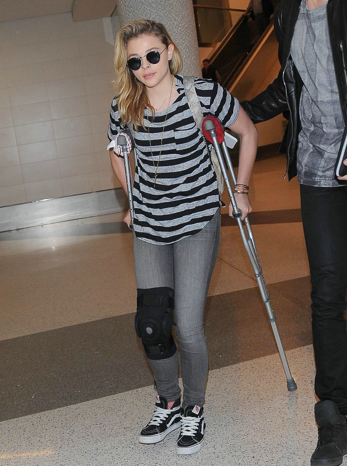 Chloe Moretz Arrives at LAX Airport With Knee Brace – December 17