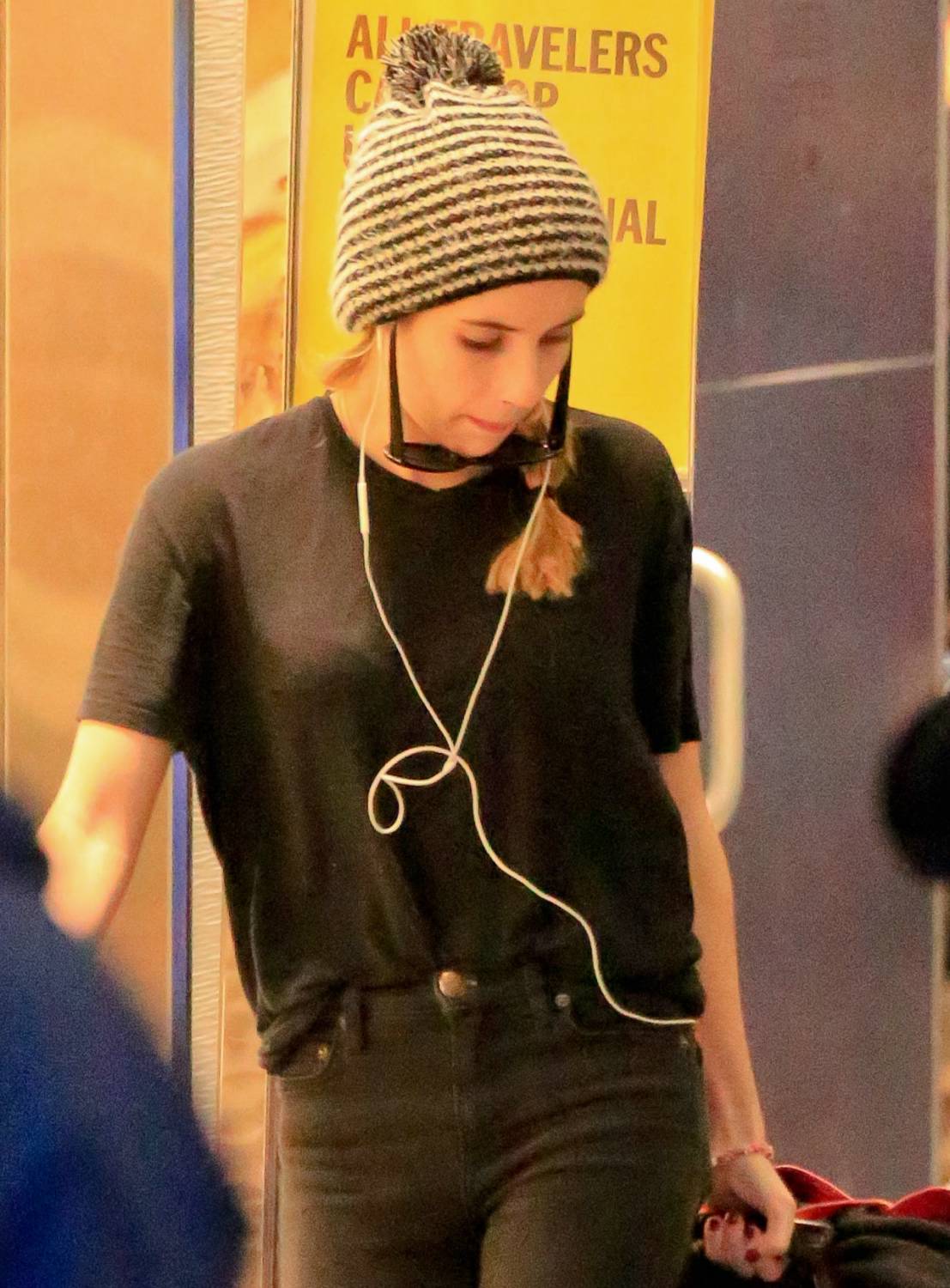 Emma Roberts at LAX arriving from a flight still wearing her Christmas socks and Isabel Merat boots on December 28, 2014.