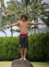 A shirtless Jaden Pinkett Smith stays in shape doing push ups at the beach in Hawaii on January 2, 2015.