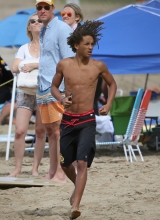 A shirtless Jaden Pinkett Smith stays in shape doing push ups at the beach in Hawaii on January 2, 2015.