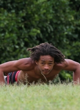 A shirtless Jaden Pinkett Smith stays in shape doing push ups at the beach in Hawaii on January 2, 2015.
