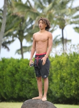 A shirtless Jaden Pinkett Smith stays in shape doing push ups at the beach in Hawaii on January 2, 2015.