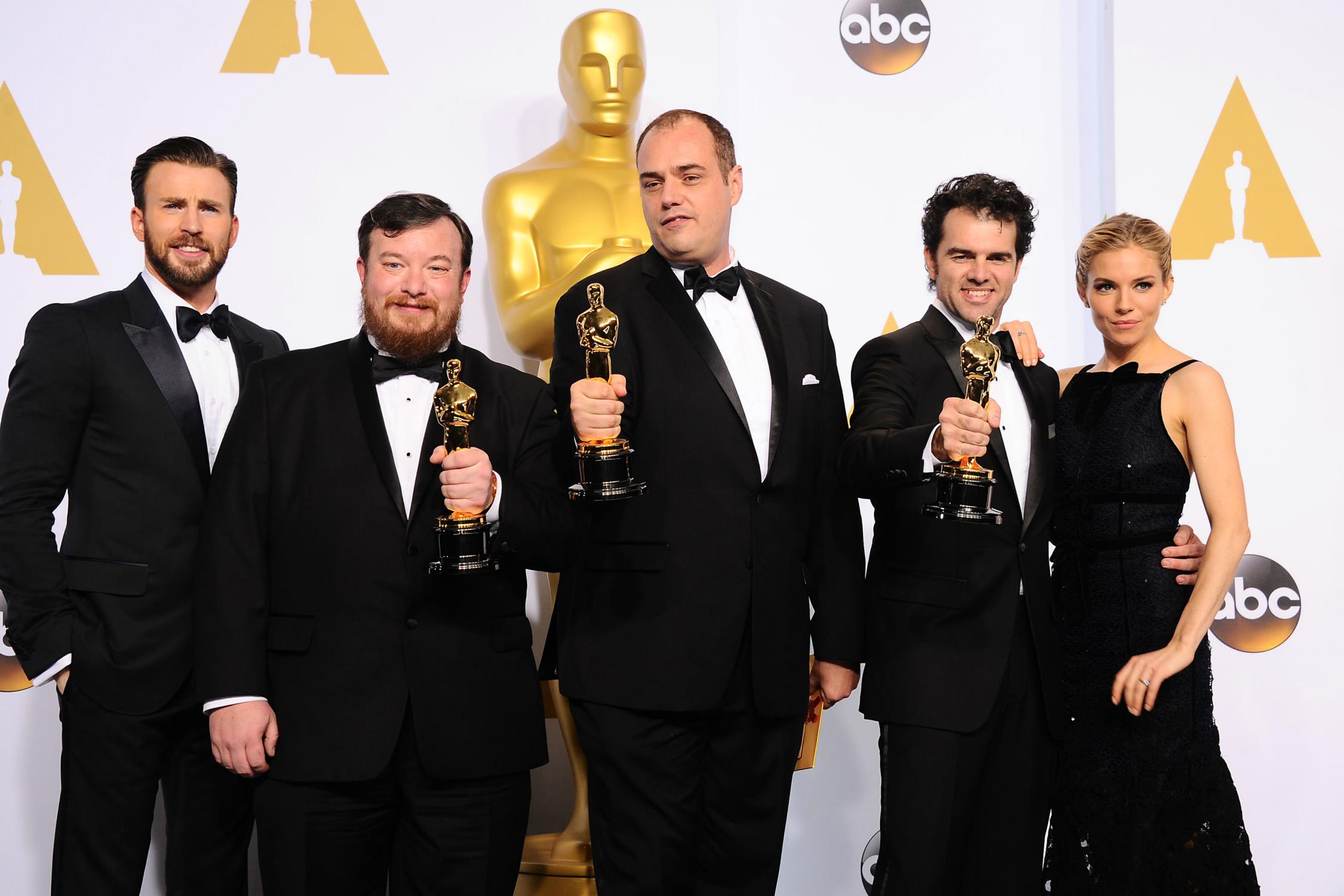 Chris Evans and Sienna Miller pose during the the 87th Annual Academy Awards - February 22