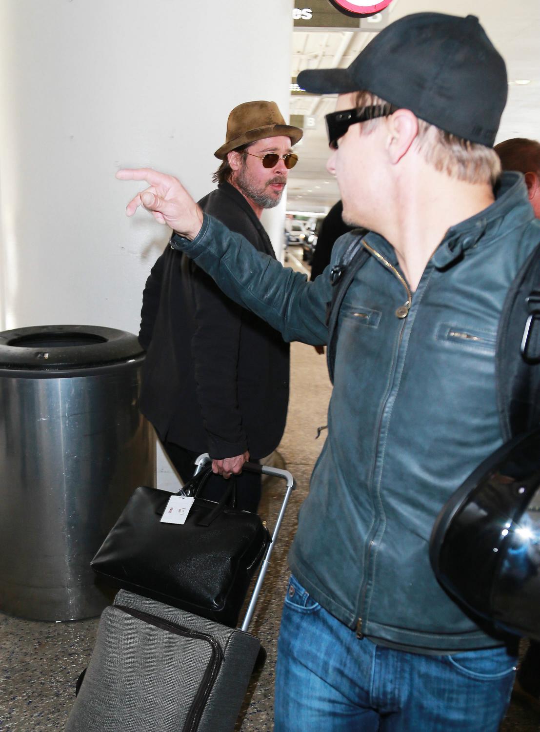 Brad Pitt and Jeremy Renner Arrives at LAX Airport - May 15